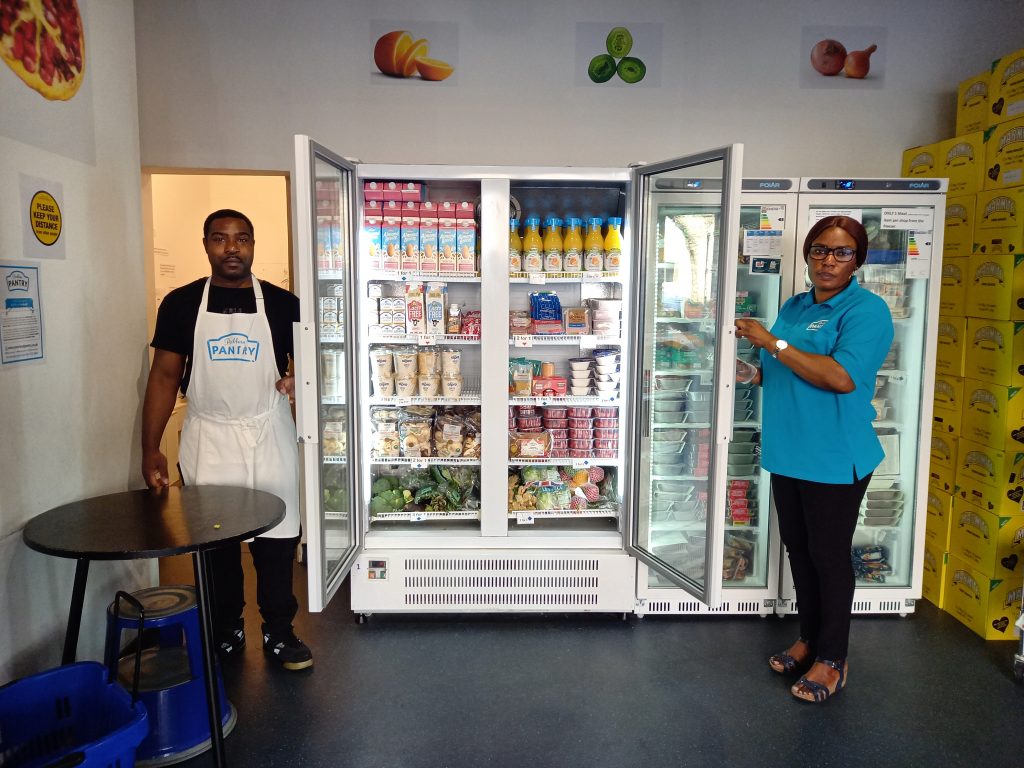 Twop people next to an open freezer