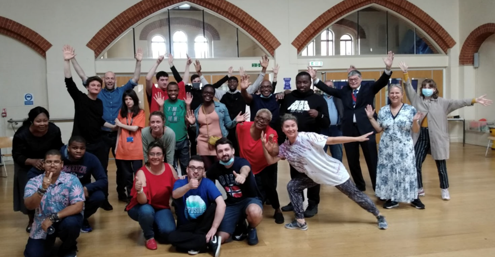 A group of people posing for the camera in a hall