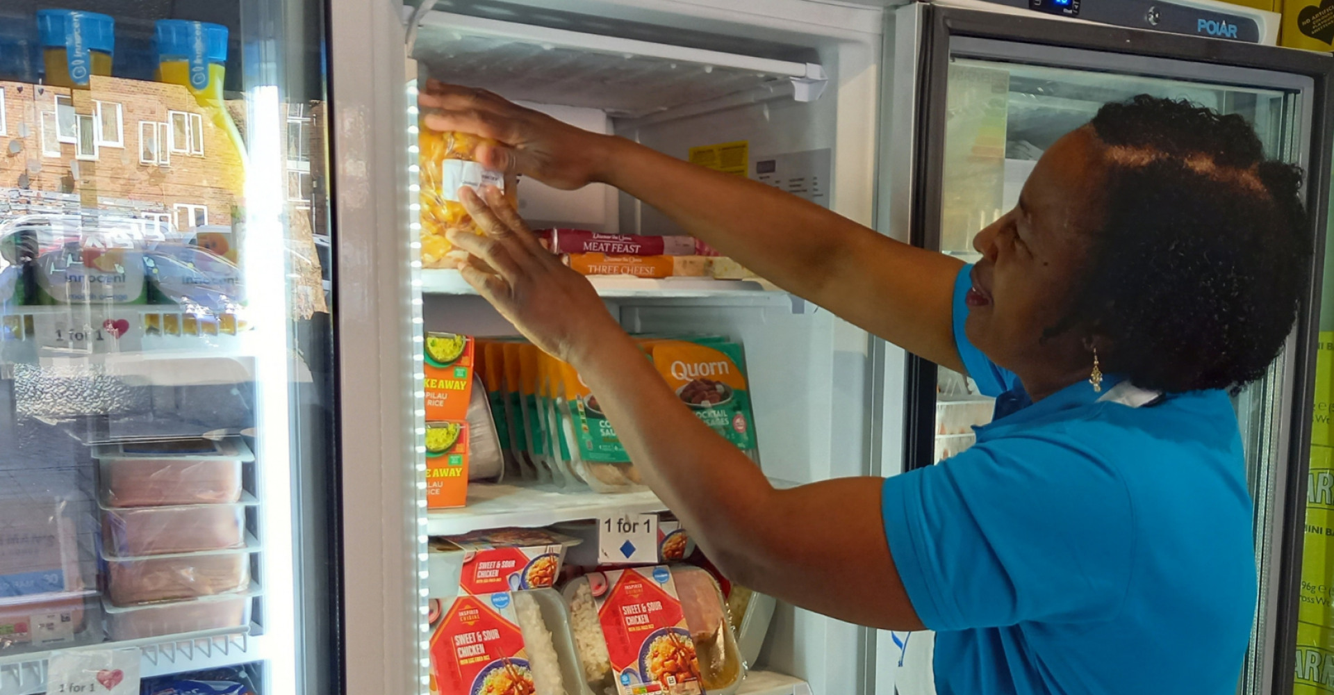 Woman putting food in a freezer