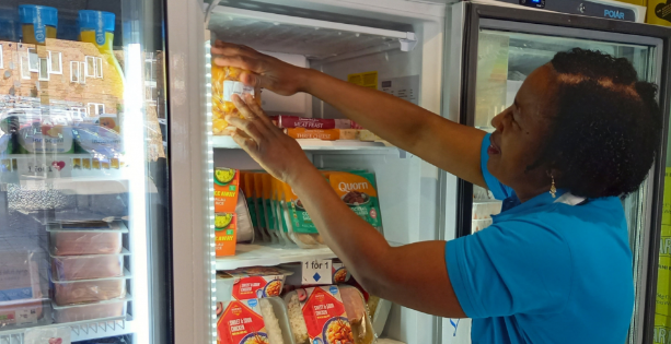 Woman putting food into a freezer