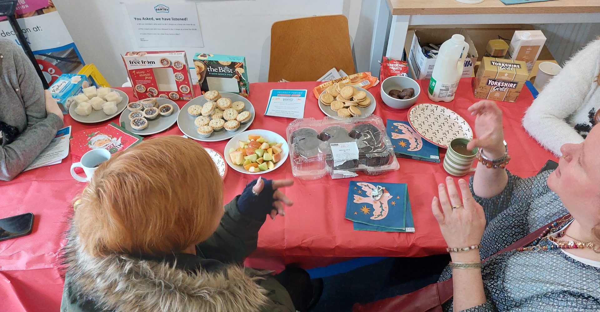 A group of people at a table with snacks